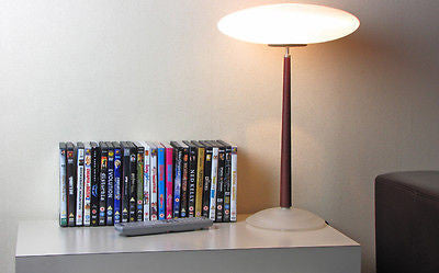Filled DVD storage rack on table.